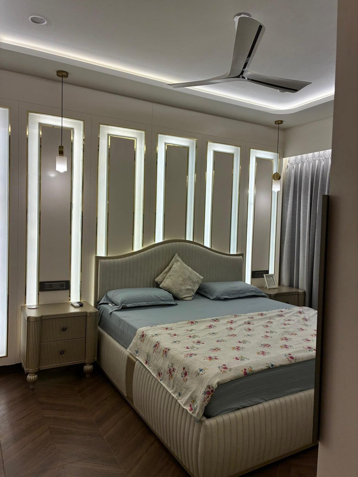 Bedroom with backlit panels and a fluted bed frame