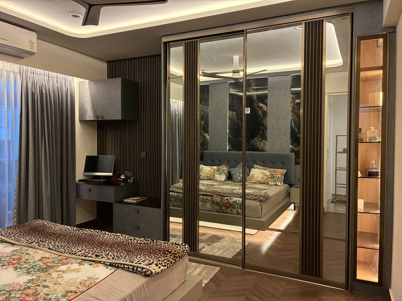 Bedroom with a mirrored wardrobe and wood-toned flooring