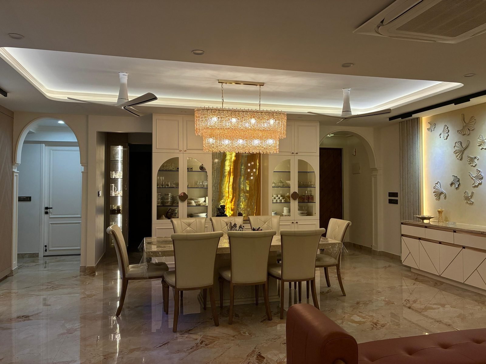 Arched dining hall with chandelier and marble floor